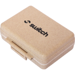 Wheat-colored 9-grid pill organizer with a black Switch Nutrition logo on the lid.