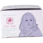 Side view of Shampoo With A Purpose Dry or Damaged Hair bar packaging with floral designs on a white background.