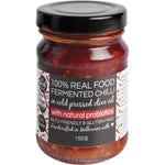 The Broth Sisters Fermented Chilli in Cold Pressed Olive Oil + Probiotics 150g glass jar on a white background.