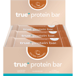 Box of 12 True Protein Salted Caramel bars in a beige display box with one individually wrapped bar in front.