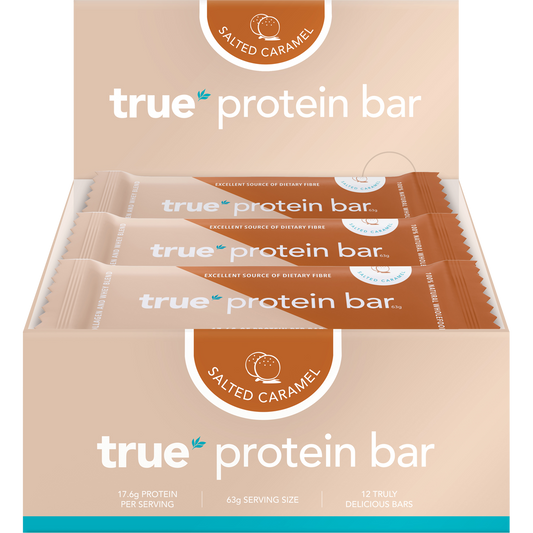 Box of 12 True Protein Salted Caramel bars in a beige display box with one individually wrapped bar in front.