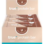 True Protein Bar Rich Chocolate 12-pack display box showing individual bars in black and gold packaging.