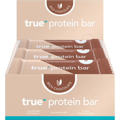 True Protein Bar Rich Chocolate 12-pack display box showing individual bars in black and gold packaging.