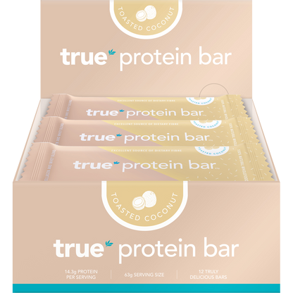 Open box of True Protein Toasted Coconut Bars showing 12 individually wrapped 63g bars in blue and white packaging.