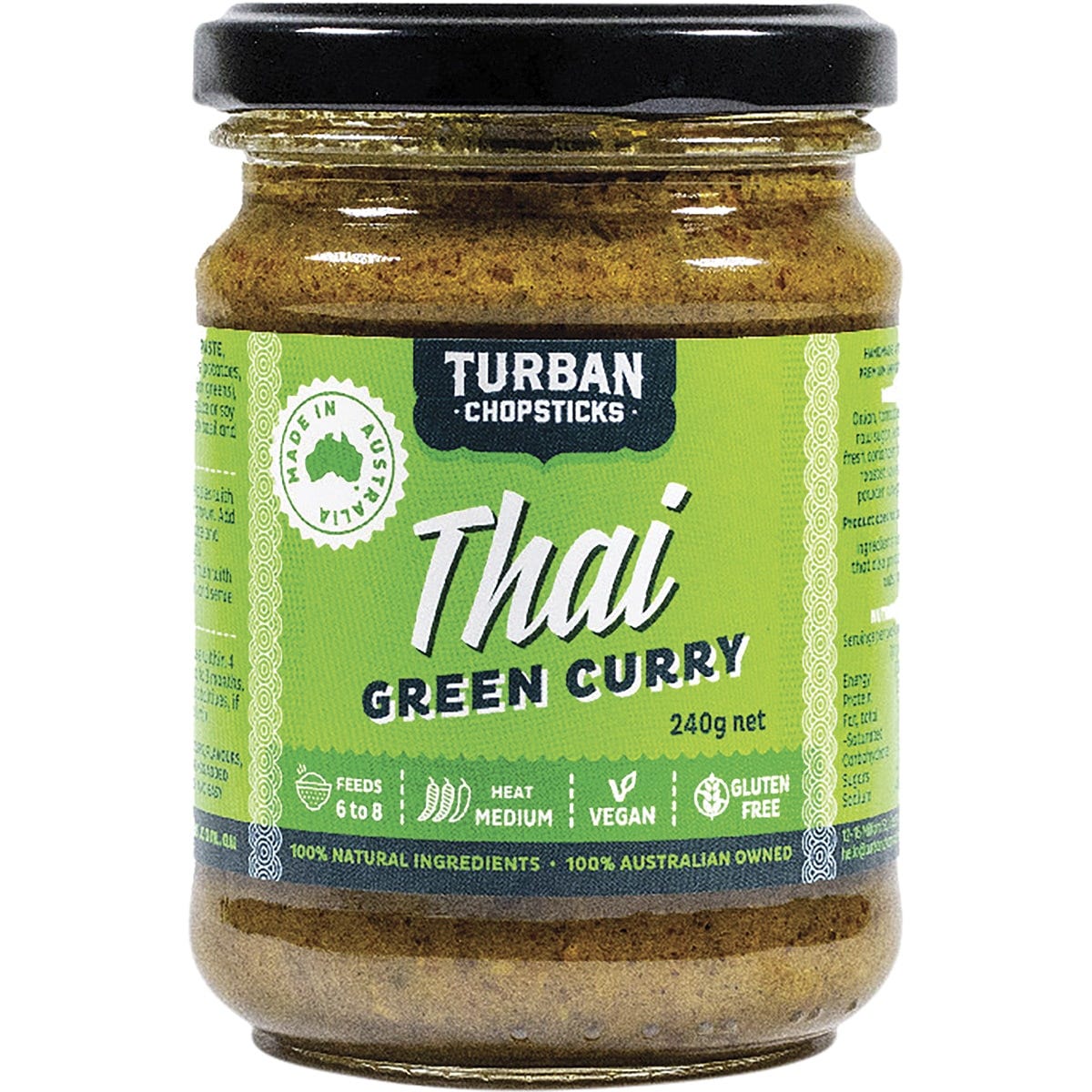 A jar of Turban Chopsticks Thai Green Curry Paste 240g with fresh ingredients like basil, coriander, and lime.