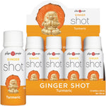 12-pack of The Ginger People Ginger Shot Turmeric 59ml bottles in a display box with fresh ginger and turmeric roots.