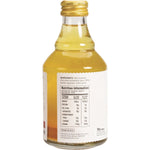 Bottle of The Ginger People 99% Turmeric Juice showing nutritional facts, ingredients, and a "No Sugar Added" label.