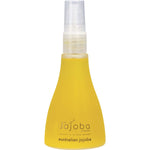 Side view of The Jojoba Company Australian Jojoba Oil 85ml glass bottle with a gold pump and clear cap.