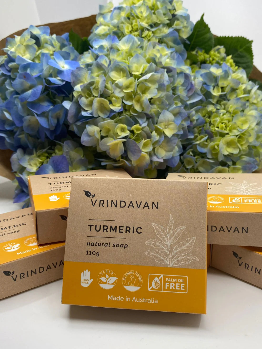Side view of a 110g bar of Vrindavan Turmeric Soap showing its golden yellow color and natural texture.