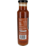 Back view of a glass bottle of sauce with a black lid and a brown label showing nutrition facts and text, on a white background.