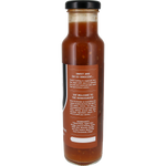 A glass bottle of hot sauce with a black cap and a brown label, photographed against a plain white background.