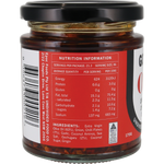 A jar of food product shown from the back, featuring a black lid and a red nutrition information label with a barcode and ingredient list.
