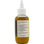 Left side of 100ml Vrindavan Batana Oil bottle showing usage instructions and botanical design on a white background.