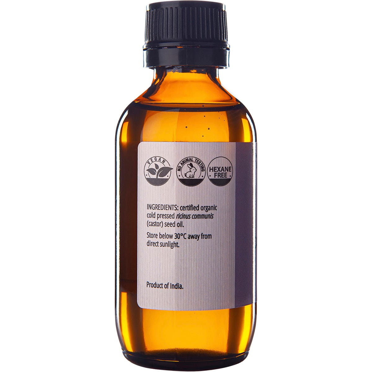 Left side of a 100ml amber glass bottle of Vrindavan Castor Oil showing a black cap and white label.