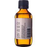 Right side of a 100ml amber glass bottle of Vrindavan Castor Oil showing nutrition and supplemental facts.