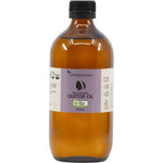 500ml amber glass bottle of Vrindavan 100% Natural Castor Oil with a black screw cap and botanical label.