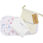Vrindavan sea shell castor oil pack with adjustable straps and organic cotton insert on a white background.