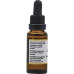 Side view of a 25ml Vrindavan Moringa Oil and White Lotus glass bottle showing directions and benefit information.