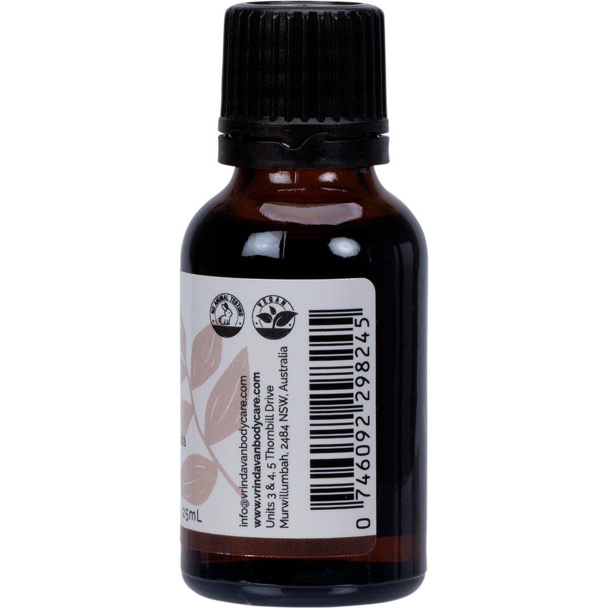 Right side of a 25ml Vrindavan Clove Bud Essential Oil bottle showing product benefits and a barcode on a white label.