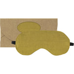 Pistachio green linen eye mask with a black elastic strap, shown next to its white and green gift box.