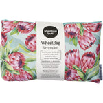 Wheatbag with pink and orange protea floral print on a white background with a green fabric reverse.