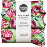 Wheatbags Love wrap-around heat pack in Protea floral print with adjustable cotton straps and a matching gift box.