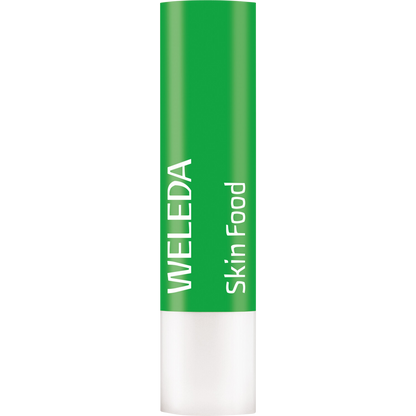Weleda Skin Food Lip Balm stick with botanical illustrations of pansy and chamomile on a green and white tube.