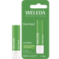 Weleda Skin Food Lip Balm stick and green cardboard packaging featuring botanical illustrations on a white background.