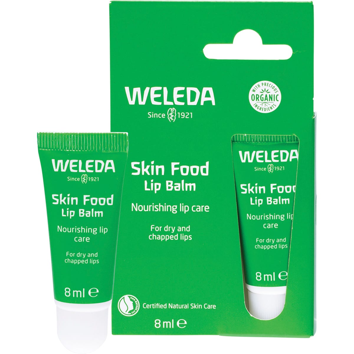 8ml tube and box of Weleda Skin Food Lip Balm, featuring a green design with botanical extracts for dry lip repair.