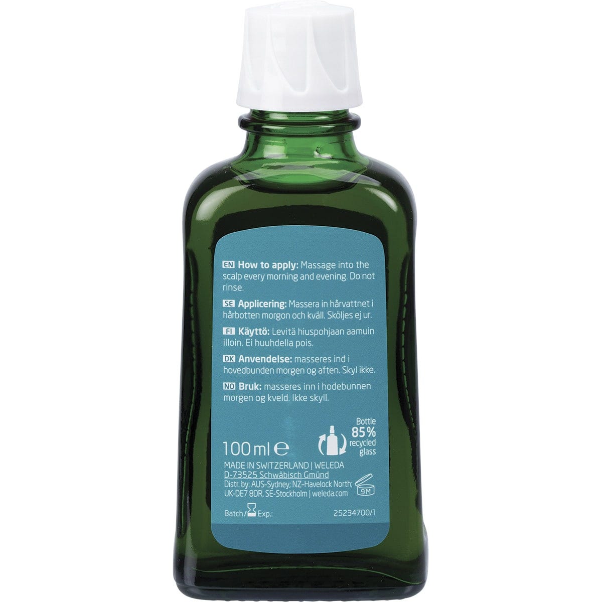 Back of a 100ml glass bottle of Weleda Revitalising Hair Tonic showing product information and instructions.