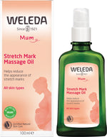 Two green glass bottles and two boxes of Weleda Stretch Mark Massage Oil for pregnancy.