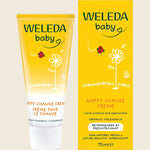 Weleda baby nappy change cream tube and packaging on a beige background
