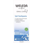 Blue and white box of Weleda Salt Toothpaste featuring peppermint leaves and natural ingredients.