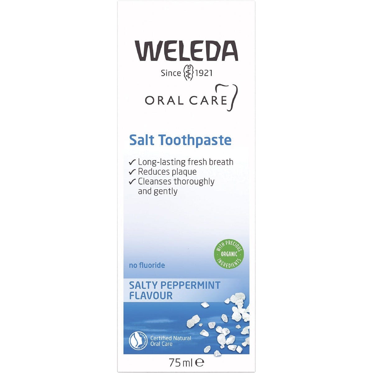 Blue and white box of Weleda Salt Toothpaste featuring peppermint leaves and natural ingredients.
