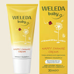 Weleda baby nappy change cream tube and packaging on a beige background