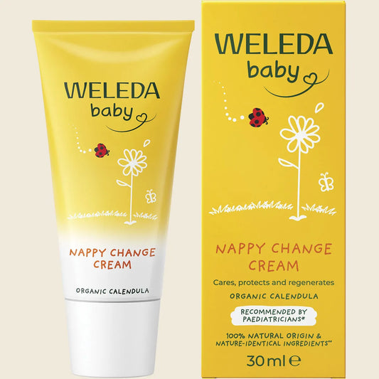 Weleda baby nappy change cream tube and packaging on a beige background