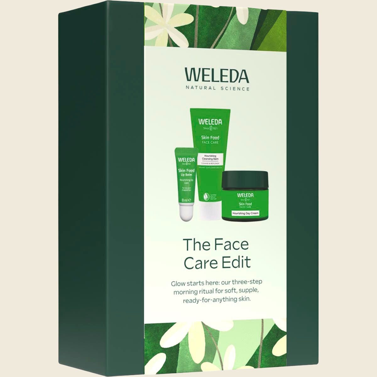 Weleda Face Care Edit 3 Pack featuring Skin Food cleansing balm, day cream, and lip balm in a green gift box.