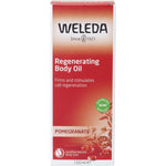 Front of a Weleda Pomegranate Regenerating Body Oil box with red accents and a pomegranate illustration.