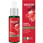 30ml dropper bottle and box of Weleda Pomegranate Firming Facial Oil, featuring a gold-toned liquid and botanical accents.