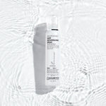 Close-up of long, wet brunette hair being sprayed with a fine mist of Giovanni detangling spray.