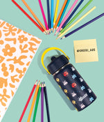 Close-up of a navy Cheeki Kids water bottle showing a soft blue carry handle and a straw lid with a pop-up mouthpiece.