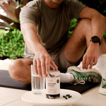 Lifestyle image of Himalayan Shilajit capsules with fresh water and natural elements on a serene background.
