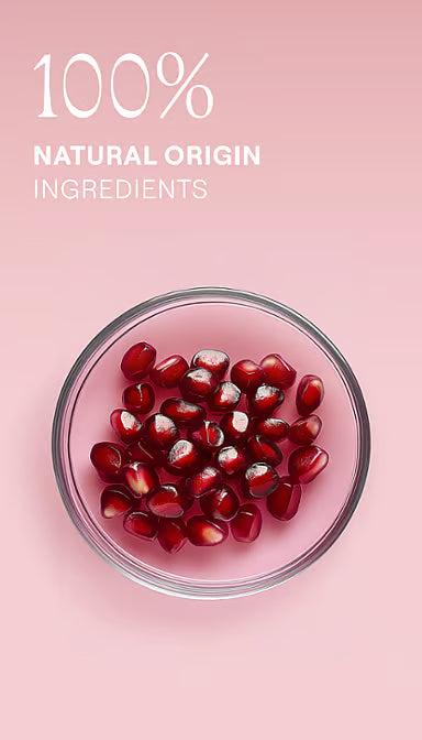 Pomegranate seeds and petals with listed ingredients for Weleda Inspire Shower Cream on a white background.