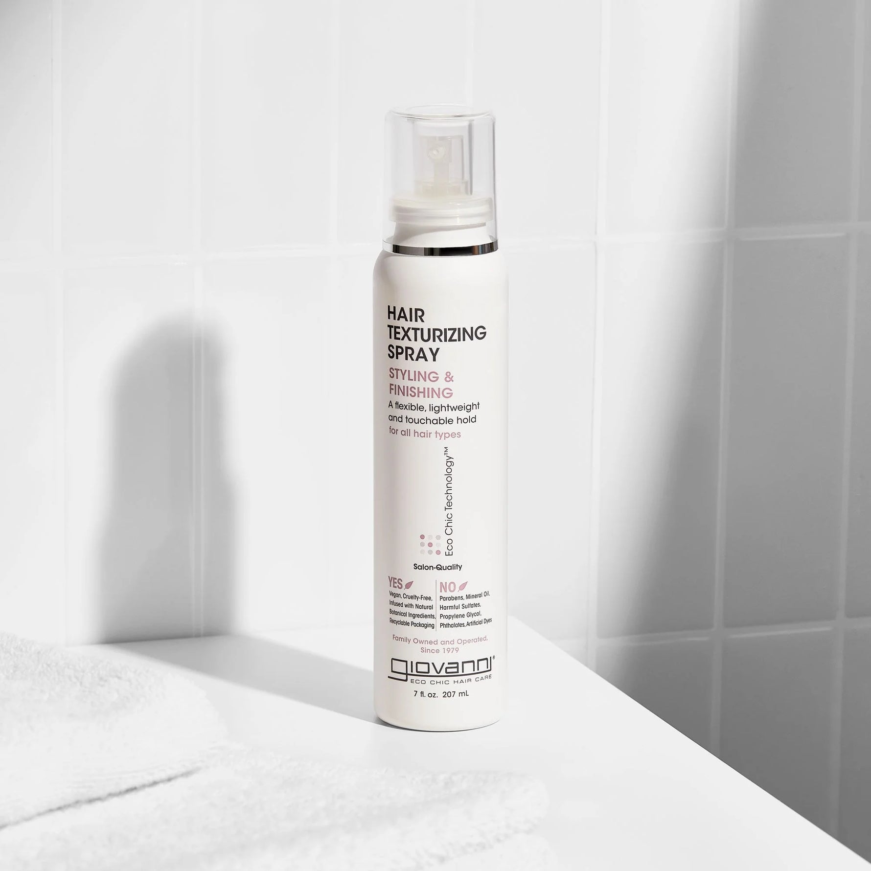207ml bottle of Giovanni Hair Texturizing Spray for all hair types with a clear cap and botanical label.